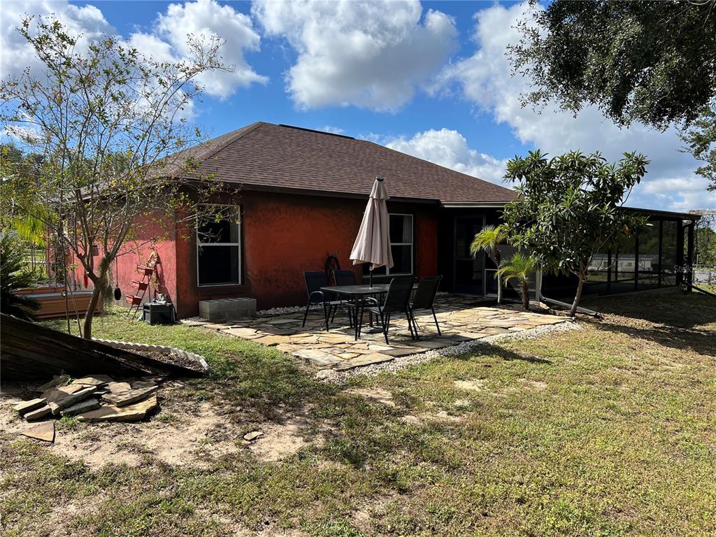 14906 Windy Mt Circle Clermont, FL 34711 - Photo 24 of 26 a backyard of a house with barbeque oven and table