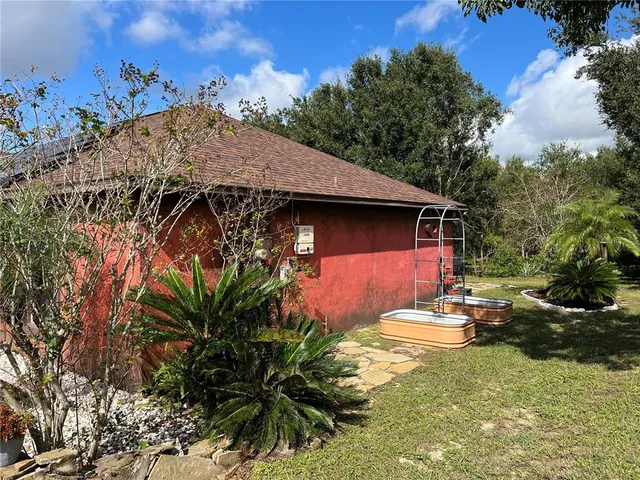 a view of a backyard with plants and a patio