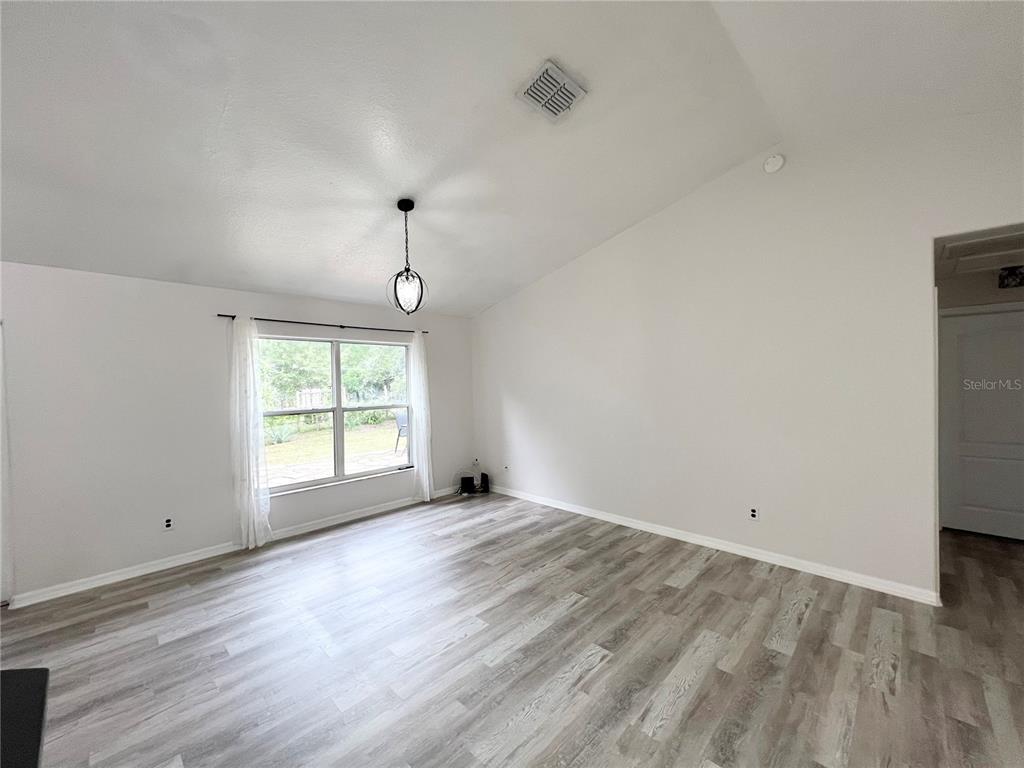 14906 Windy Mt Circle Clermont, FL 34711 - Photo 6 of 26 an empty room with wooden floor and windows