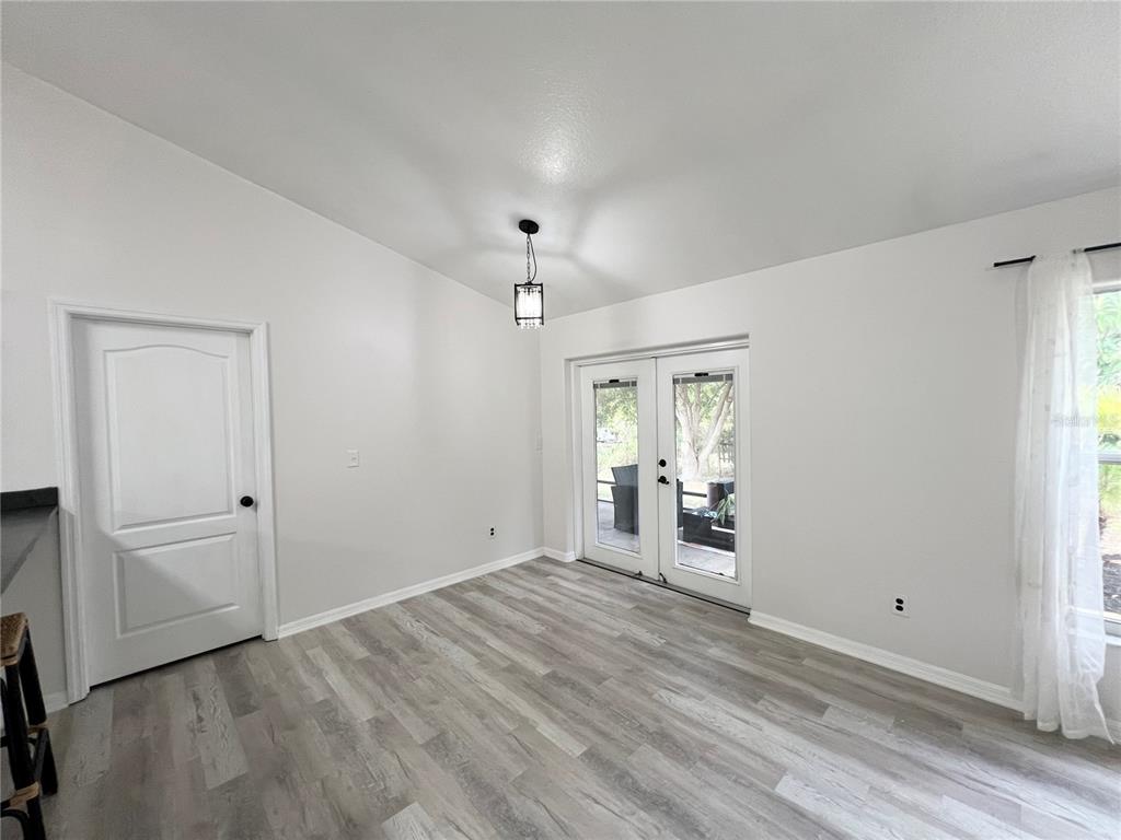 14906 Windy Mt Circle Clermont, FL 34711 - Photo 7 of 26 wooden floor in an empty room with a window