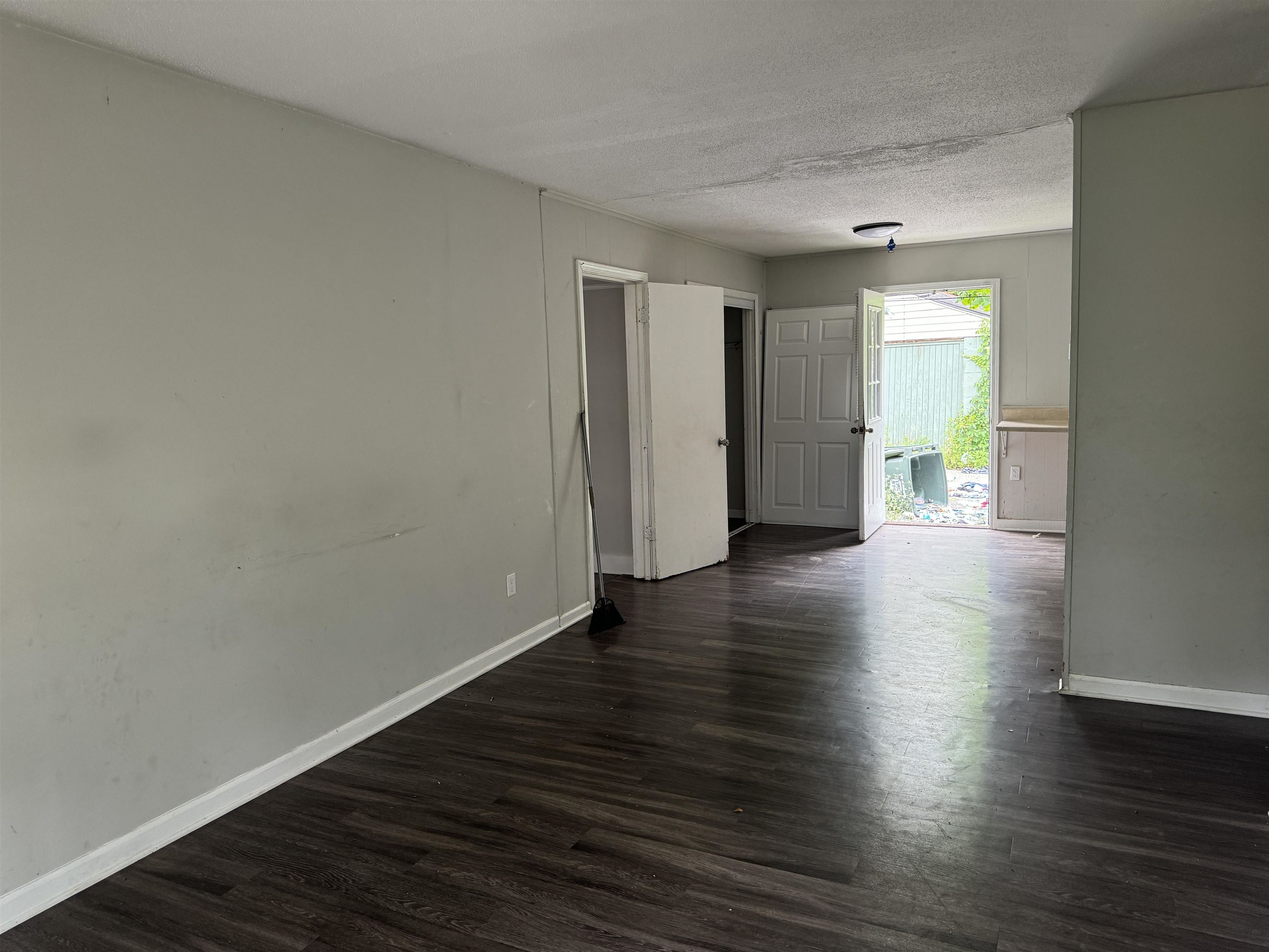 4613 Sumners Wells Road Memphis, TN 38118 - Photo 2 of 6 Empty room featuring a textured ceiling and dark hardwood / wood-style floors