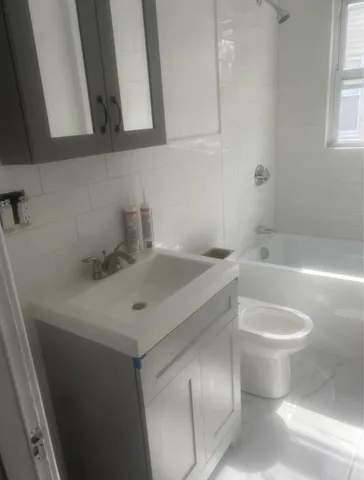 a bathroom with a sink toilet and bathtub