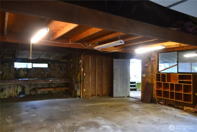 a view of a house with large windows and a large tree