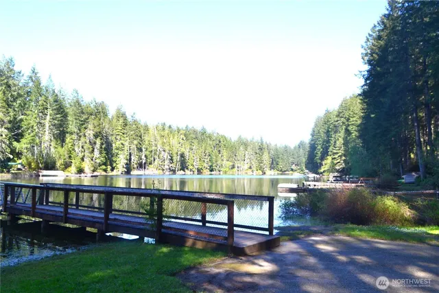 a view of backyard with a table and chairs under an umbrella