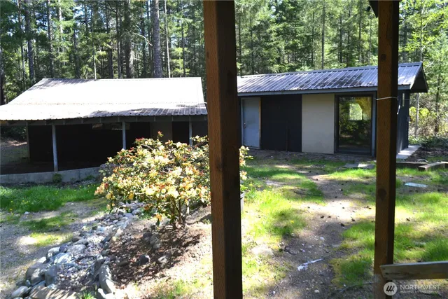a view of a house with a yard potted plants