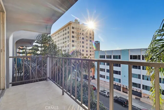 a view of staircase with railing and a chandelier