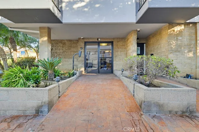 a view of a house with potted plants