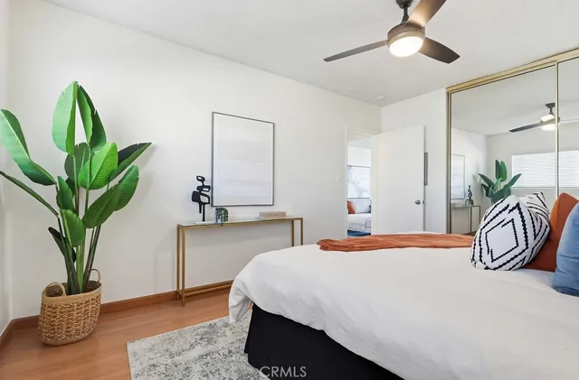 a bedroom with a bed and a potted plant