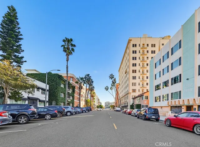 a buildings with car parked in front of it