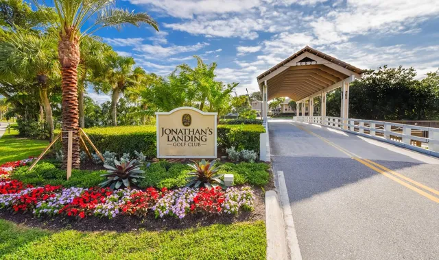 a sign board with a house and garden space