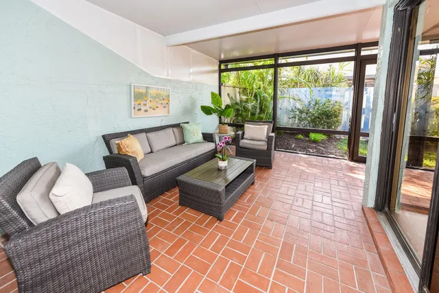 a living room with furniture and a floor to ceiling window