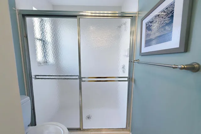 a bathroom with a glass shower door