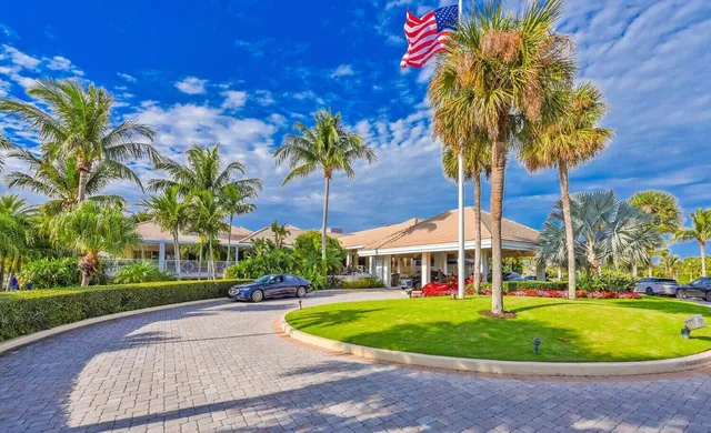 a front view of a house with swimming pool and porch with furniture