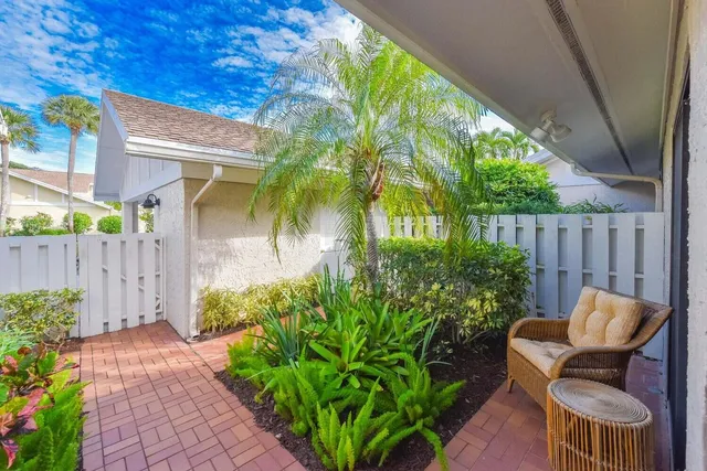 a view of a chair and table in the backyard