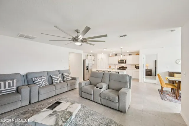 a living room with furniture and a chandelier