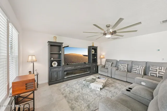 a living room with furniture and a flat screen tv