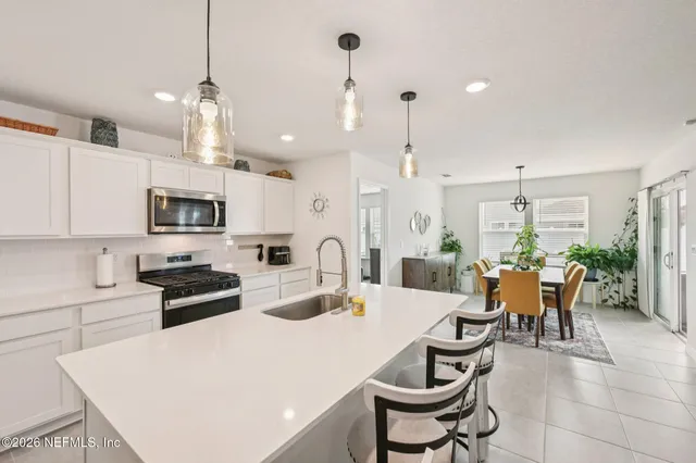 a large kitchen with a table and chairs