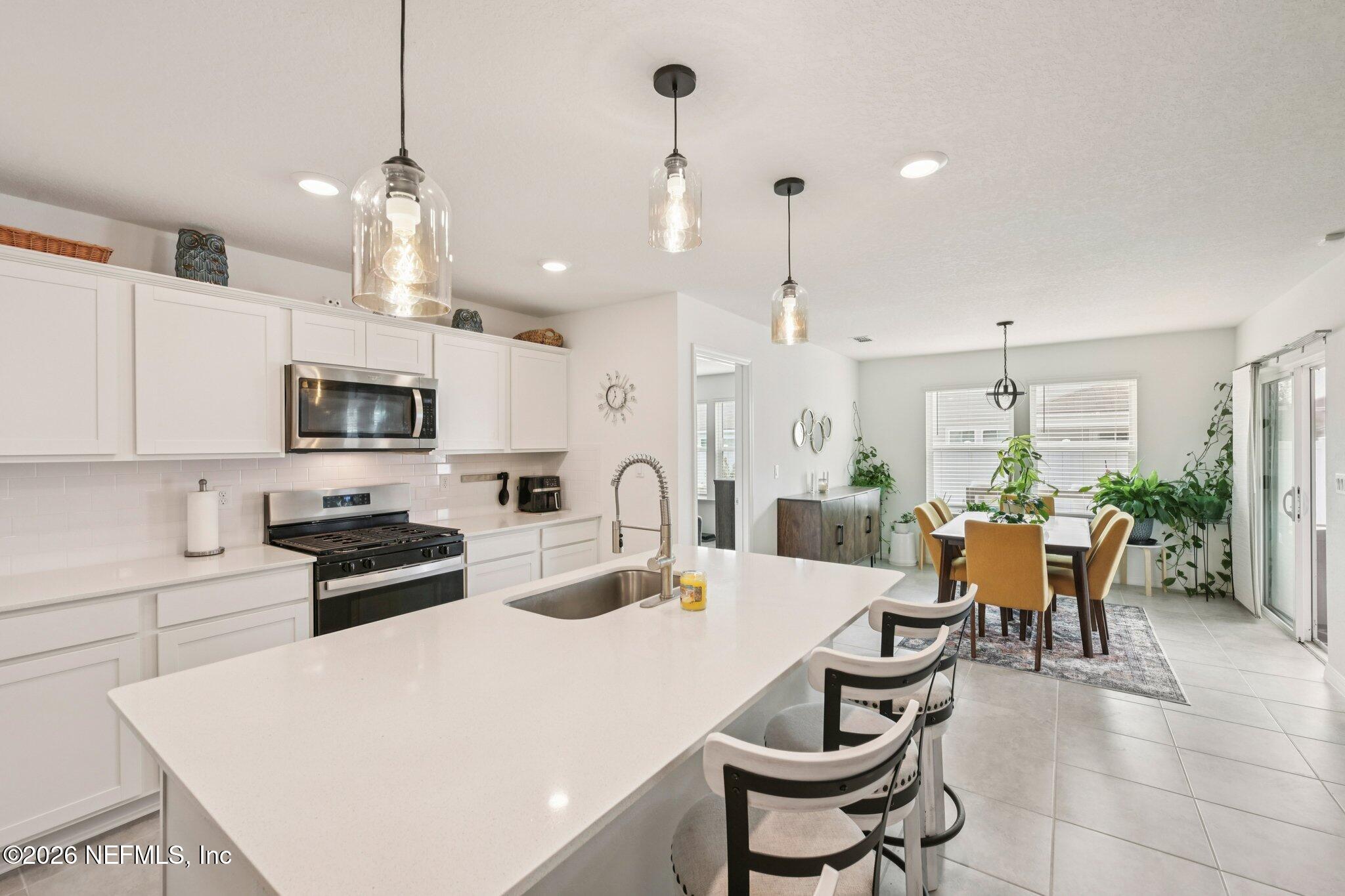 5508 Integrity Way Jacksonville, FL 32244 - Photo 16 of 34 a large kitchen with a table and chairs