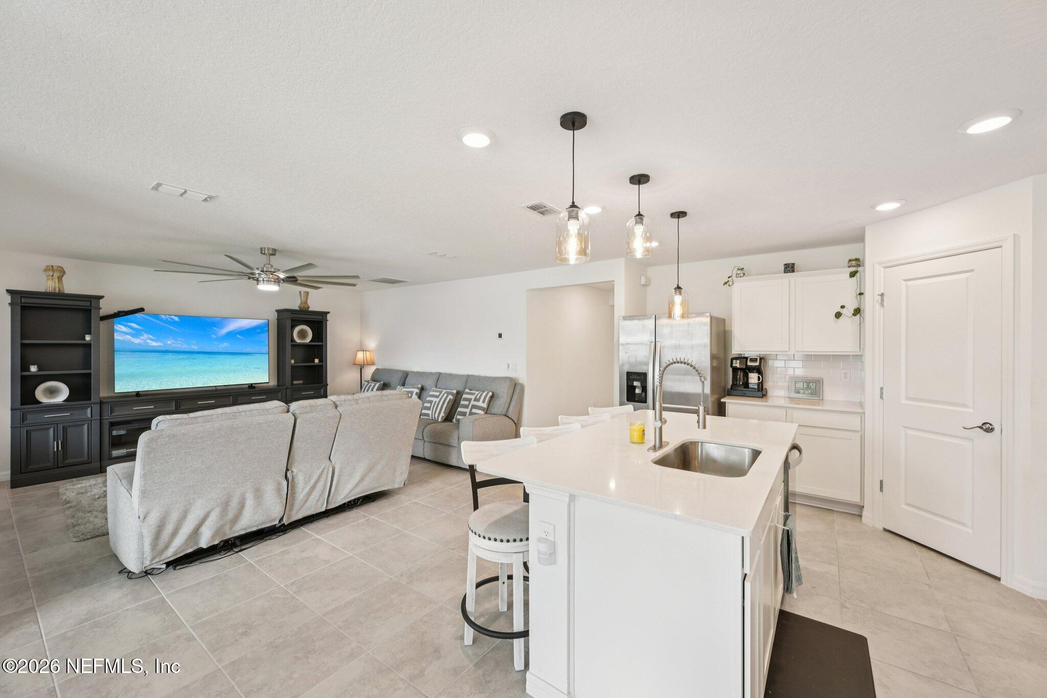 5508 Integrity Way Jacksonville, FL 32244 - Photo 17 of 34 a living room with furniture and a chandelier