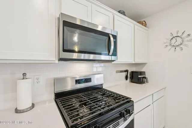 a kitchen with a stove and a microwave