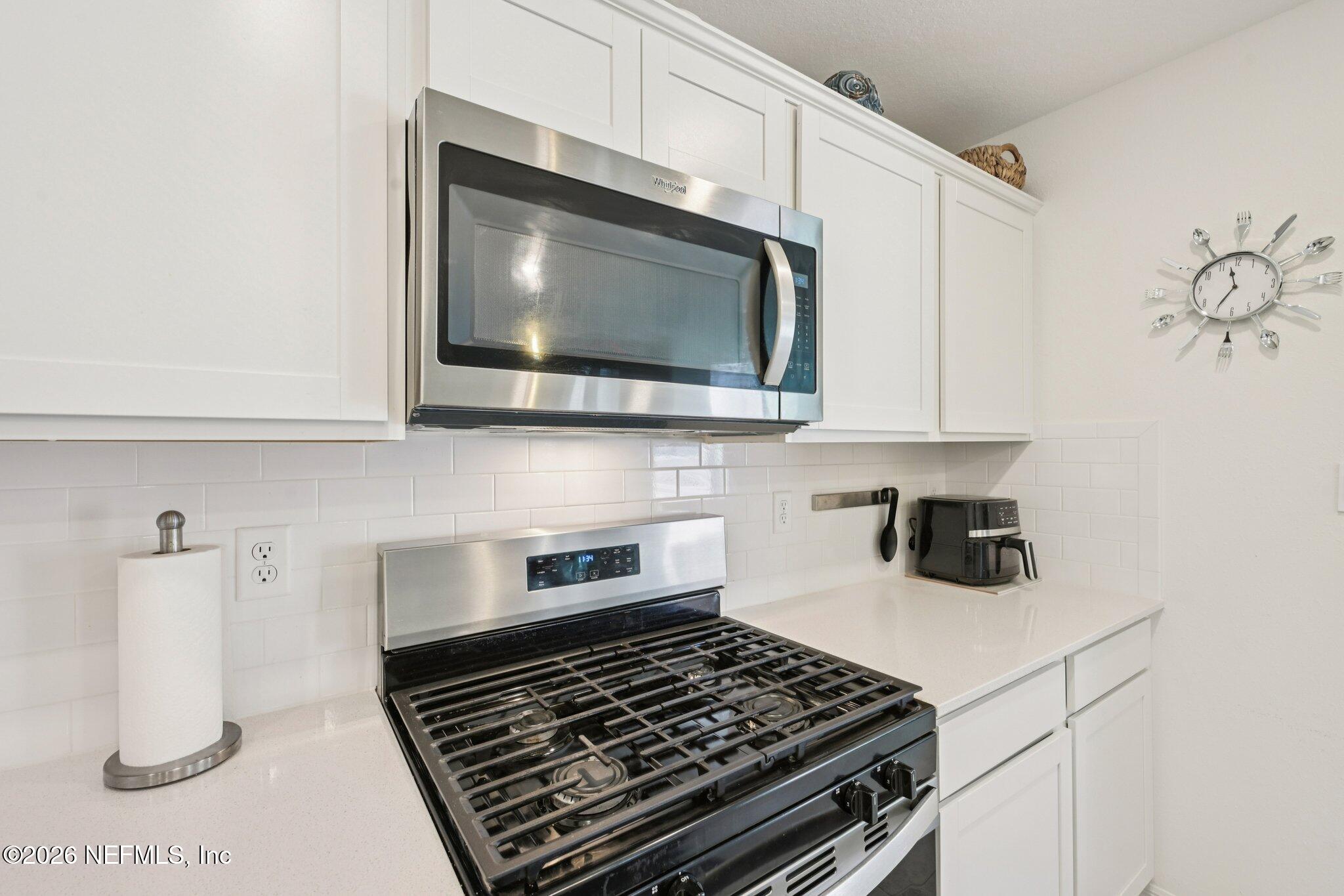 5508 Integrity Way Jacksonville, FL 32244 - Photo 20 of 34 a kitchen with a stove and a microwave