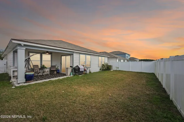 a view of a house with backyard and porch