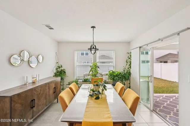 a living room with furniture chandelier and a rug