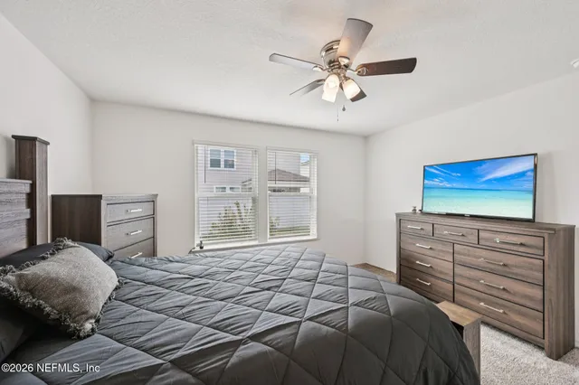 a bedroom with a bed and a television