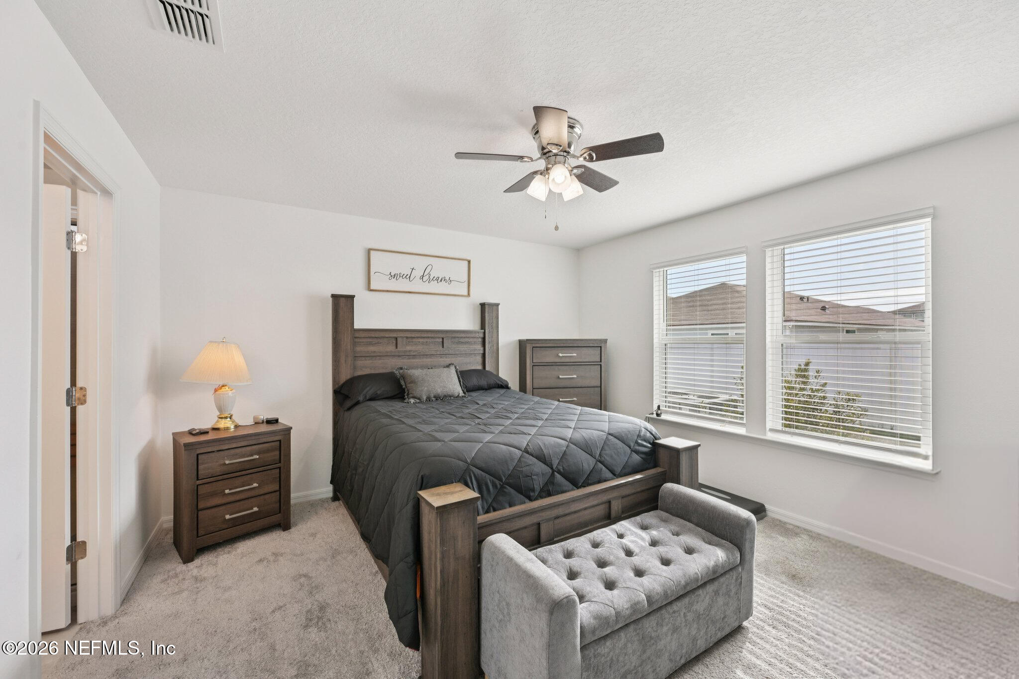 5508 Integrity Way Jacksonville, FL 32244 - Photo 26 of 34 a bedroom with a bed a couches and large windows