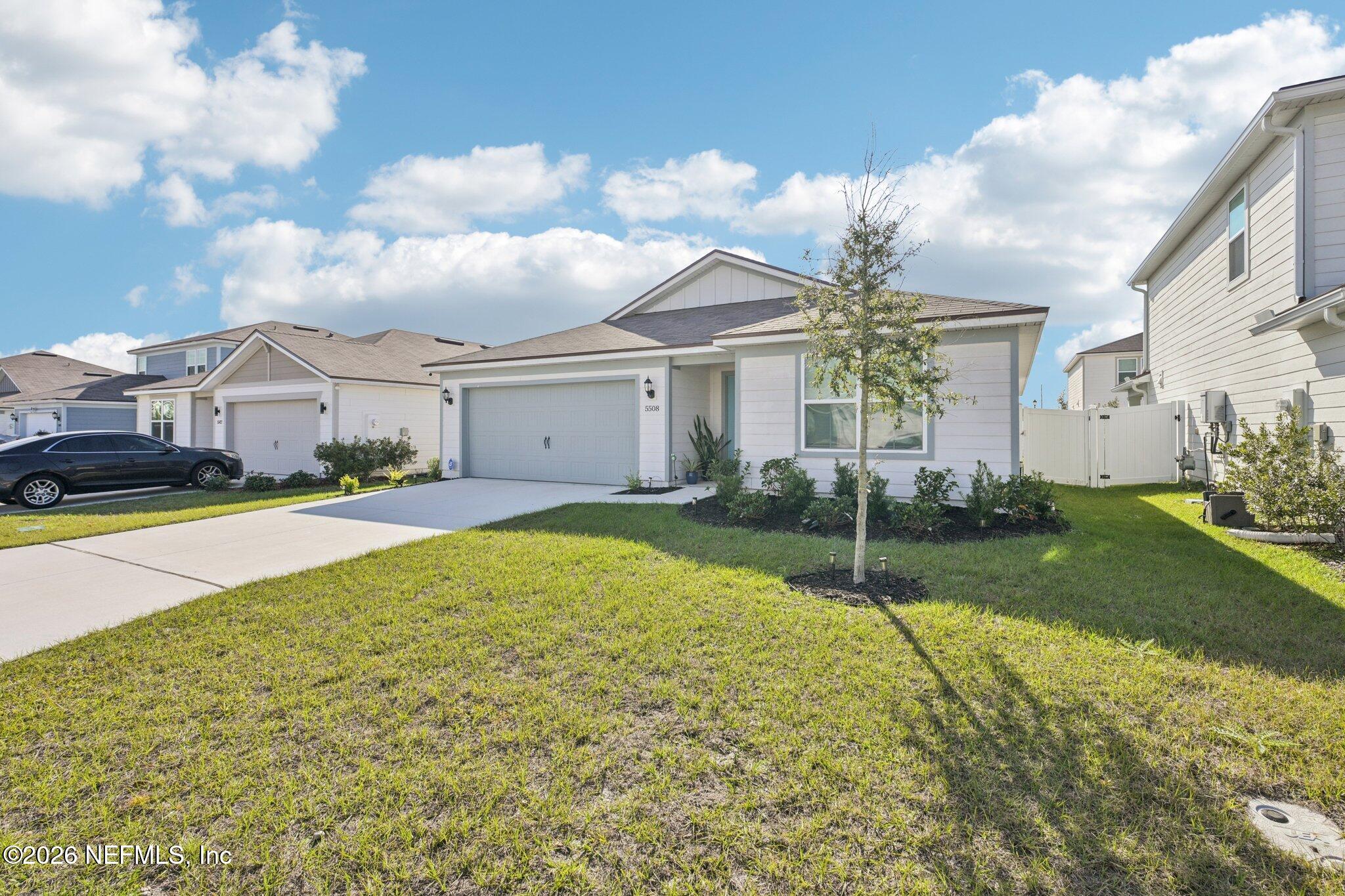 5508 Integrity Way Jacksonville, FL 32244 - Photo 3 of 34 a view of yellow house with a big yard and potted plants