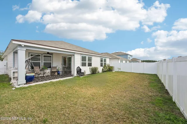 a view of a house with backyard and porch
