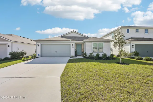 a front view of a house with a yard and garage