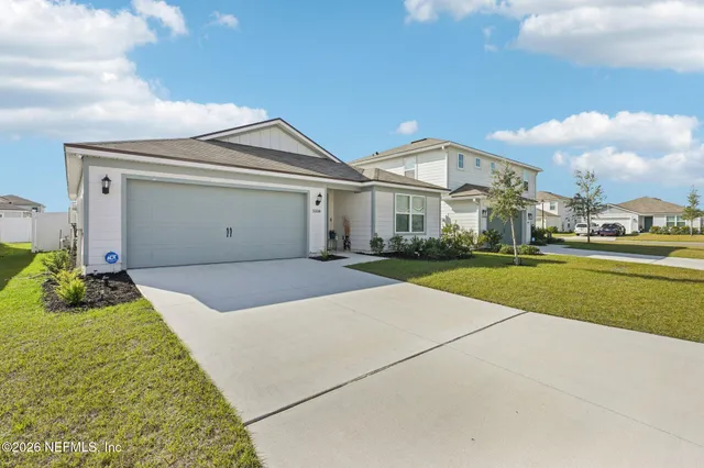 a view of an house with backyard and porch