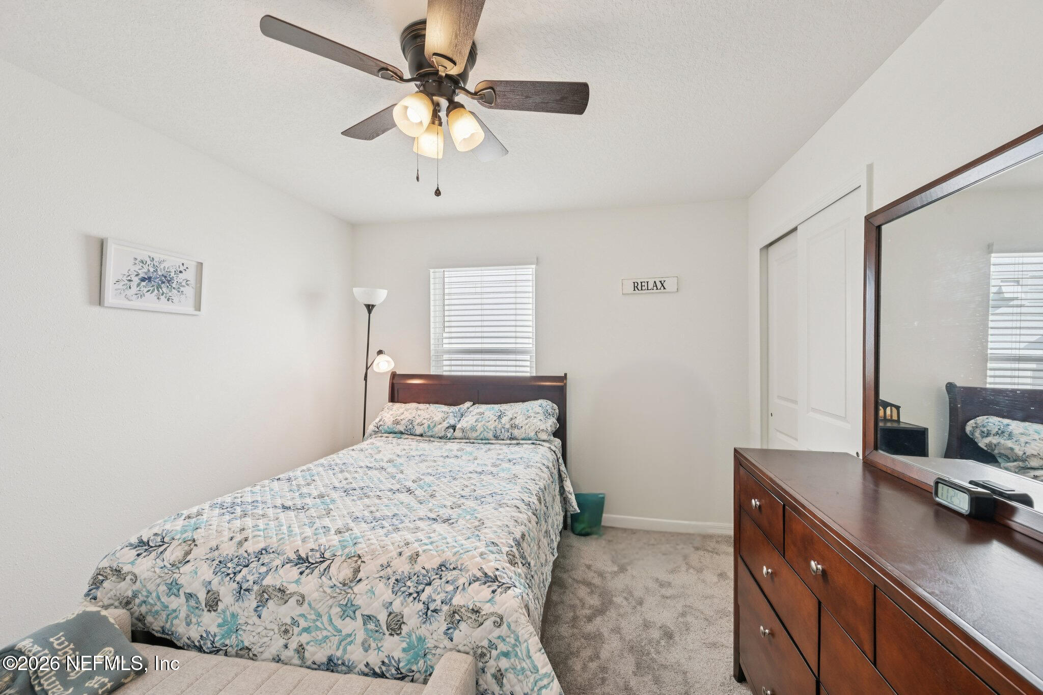 5508 Integrity Way Jacksonville, FL 32244 - Photo 7 of 34 a bedroom with a large bed and a chandelier
