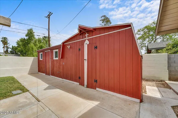 a view of wooden house with a small yard
