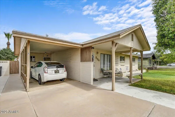a car parked in front of house with a yard