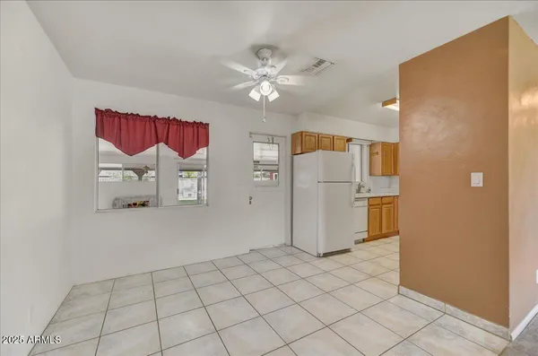 a view of a kitchen with a refrigerator and a stove top oven