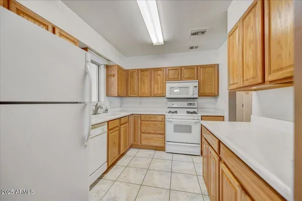 a kitchen with stainless steel appliances granite countertop a refrigerator sink stove and microwave