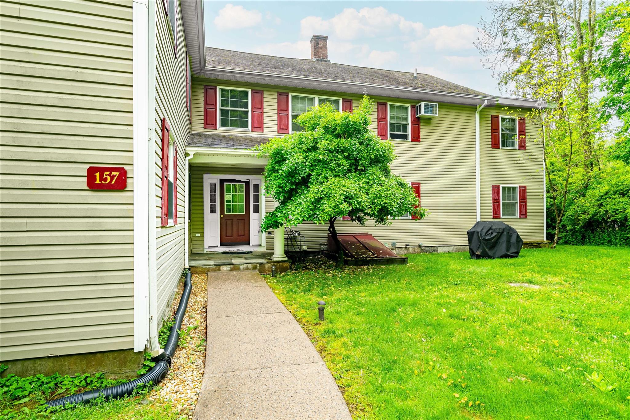 159 Highway 202 Somers, NY 10589 - Photo 30 of 48 a front view of a house with a garden and plants
