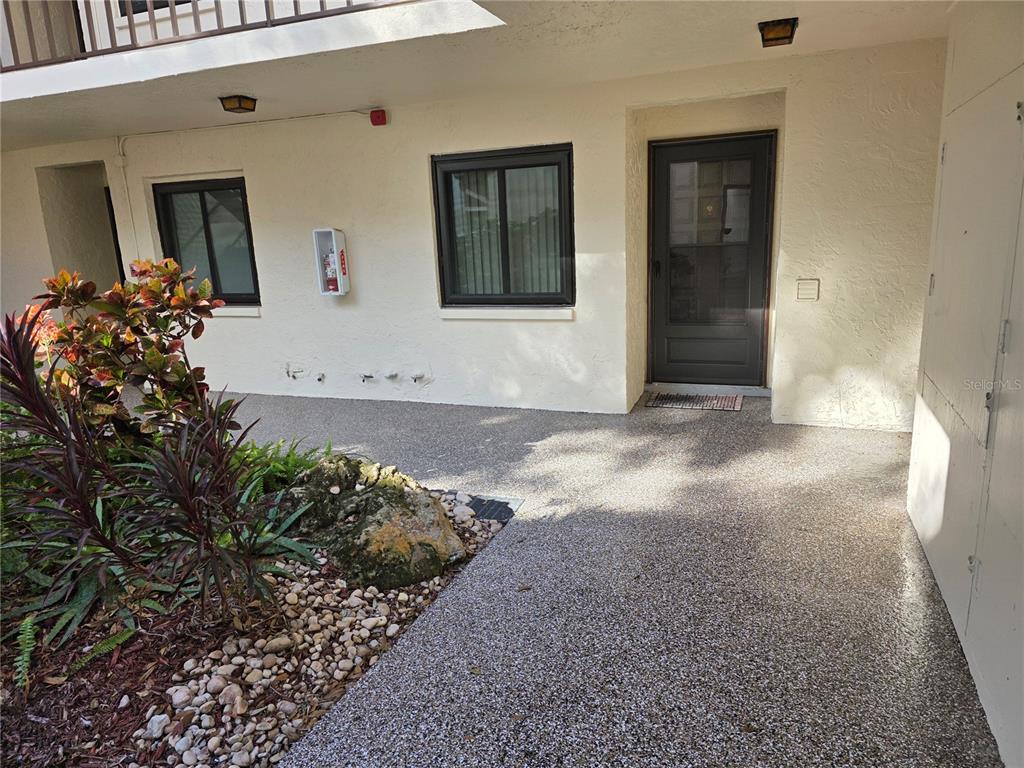 2207 Belleair Road, Unit B6 Clearwater, FL 33764 - Photo 2 of 21 a view of a hallway with wooden floor and a potted plant