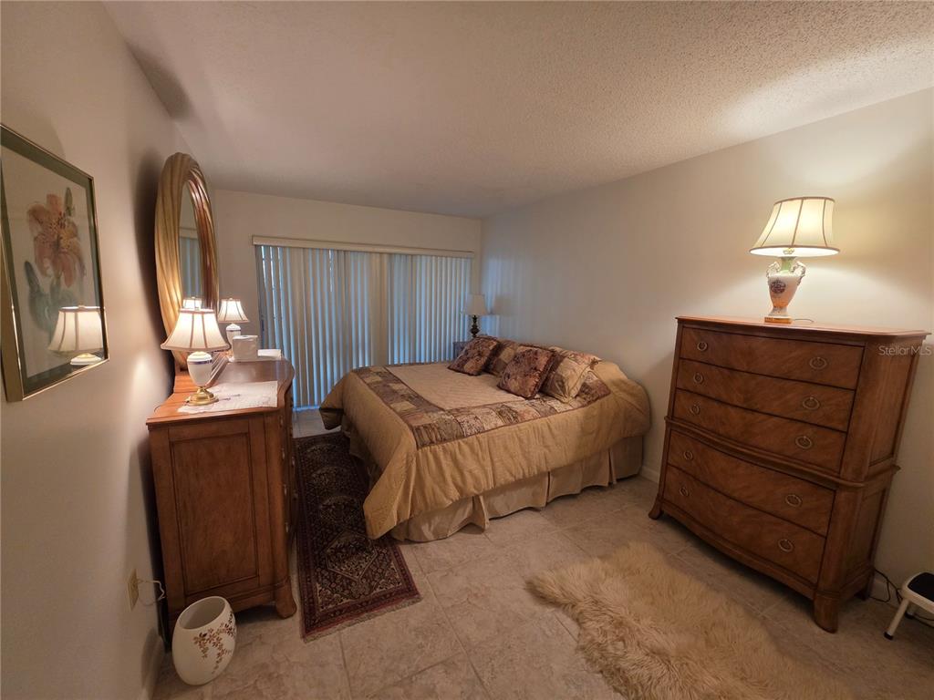 2207 Belleair Road, Unit B6 Clearwater, FL 33764 - Photo 5 of 21 a bedroom with a bed and a mirror