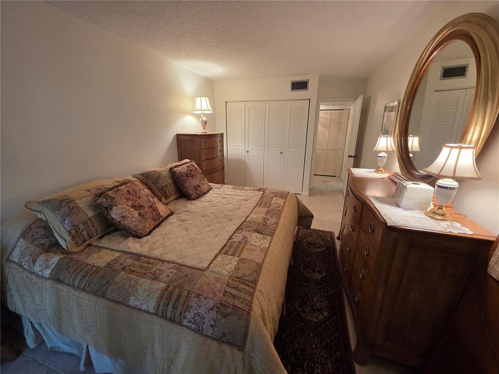 2207 Belleair Road, Unit B6 Clearwater, FL 33764 - Photo 6 of 21 a bedroom with a bed and a mirror
