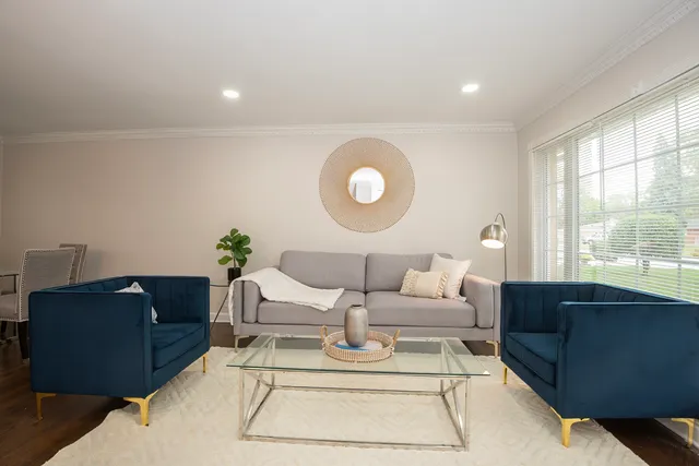 a living room with furniture and a large window