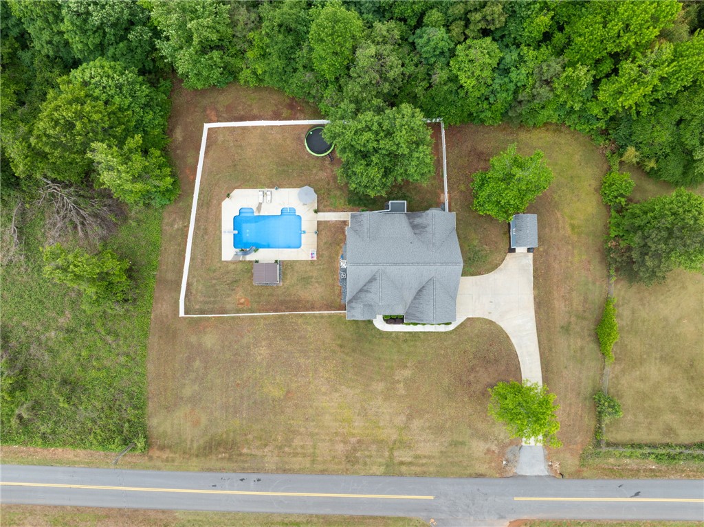 1050 Old Dacusville Road Easley, SC 29640 - Photo 30 of 33 An aerial view showcases a residence with a private pool, nestled amidst verdant landscaping.