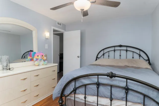 a bedroom with a bed and a dresser