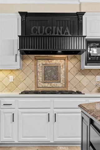 a kitchen with stainless steel appliances kitchen island granite countertop a sink and cabinets