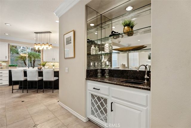 a kitchen with a sink and white cabinets