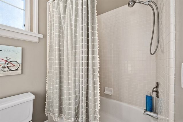 a patio with table and chairs and potted plants