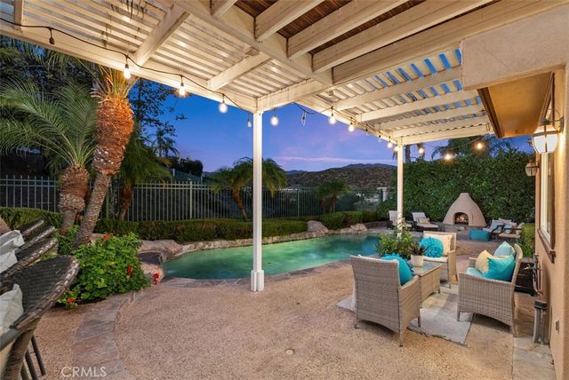 a view of a patio with table and chairs potted plants