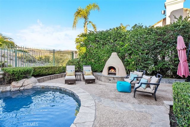 a view of a patio with table and chairs and potted plants